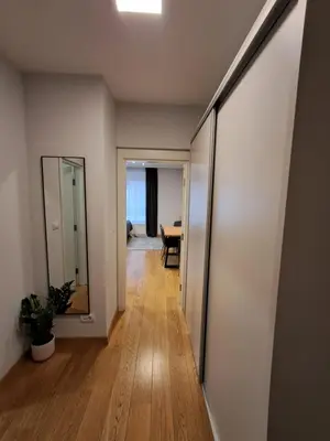 a hallway of a house with a mirror and a table at Apartment Premier 1 A Blok in Belgrade