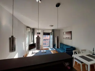 a living room with a blue couch and a table at Apartment Premier 1 A Blok in Belgrade