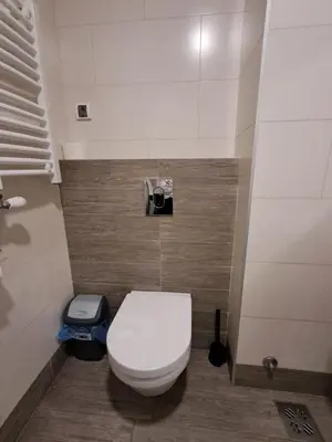a bathroom with a white toilet in a room at Apartment Premier 1 A Blok in Belgrade