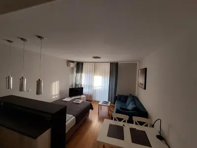 a hotel room with a bed and a couch at Apartment Premier 1 A Blok in Belgrade
