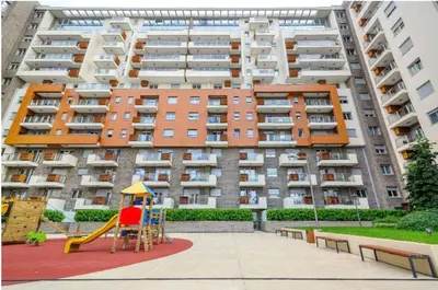 a large apartment building with a playground in front of it at Apartment Premier 2 A Blok in Belgrade