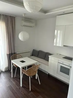a living room with a couch and a table and chairs at Apartment Premier 2 A Blok in Belgrade