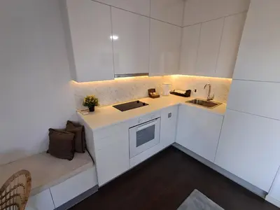 a small kitchen with white cabinets and a sink at Apartment Premier 2 A Blok in Belgrade
