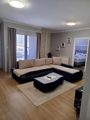 a living room with a couch and a table at Apartman Ana in Borča