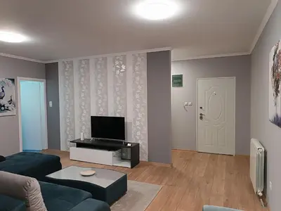a living room with a couch and a tv at Apartman Ana in Borča