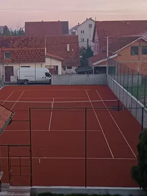 a tennis court with a net on top of it at Apartman Ana in Borča