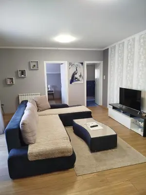 a living room with a couch and a table at Apartman Ana in Borča