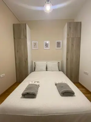 a bedroom with a large white bed with two pillows at Apartman Mandić in Belgrade