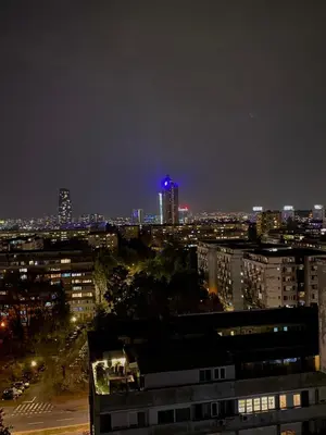 a view of a city at night with a blue light at Apartman Mandić in Belgrade