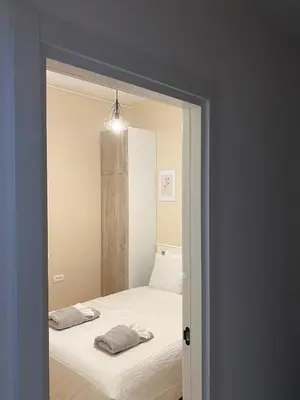 a bedroom with a bed and a mirror at Apartman Mandić in Belgrade