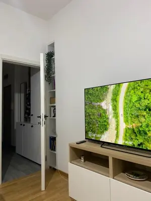 a living room with a flat screen tv on a cabinet at Apartman Mandić in Belgrade
