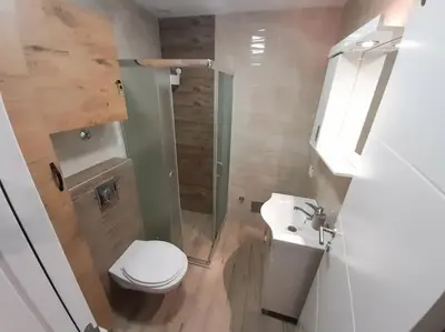 a bathroom with a toilet and a shower and a sink at Apartment paku 3 New Belgrade in Belgrade