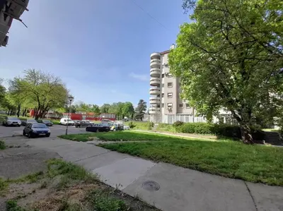 a parking lot with cars parked in front of a building at Apartment paku 3 New Belgrade in Belgrade