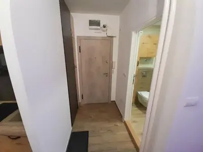 a hallway with a door and a toilet in a room at Apartment paku 3 New Belgrade in Belgrade
