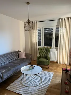 a living room with a couch and a table at Apartman Aurora in Arandjelovac