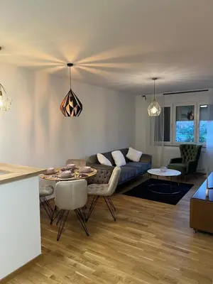 a living room with a couch and a table at Apartman Aurora in Arandjelovac