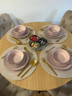 a wooden table with plates and utensils on it at Apartman Aurora in Arandjelovac