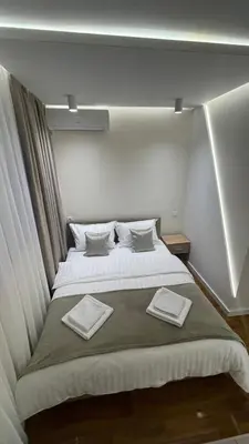a bedroom with a large bed with two towels on it at Luka Luxury Suite in Belgrade