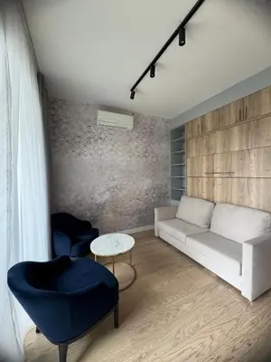 a living room with a couch and a table at BW Lux Apartments in Sajmište