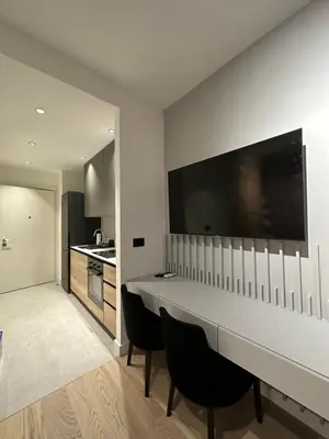 a kitchen with a long table and chairs in a room at BW Lux Apartments in Sajmište