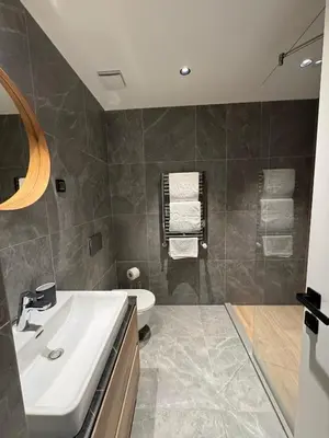 a bathroom with a sink and a bath tub at BW Lux Apartments in Sajmište