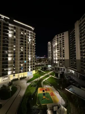 a view of a city at night with buildings at BW Lux Apartments in Sajmište
