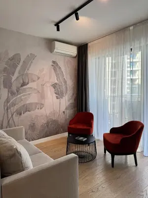 a living room with a couch and two chairs at BW Lux Apartments in Sajmište