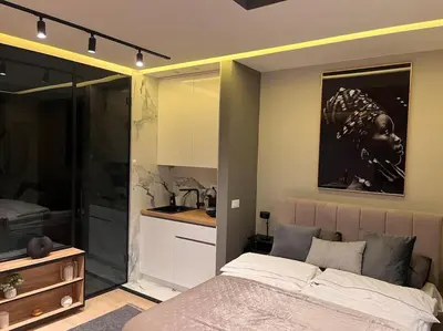 a bedroom with a bed and a kitchen in it at Pleasure Apartment - Belgrade Waterfront in Sajmište
