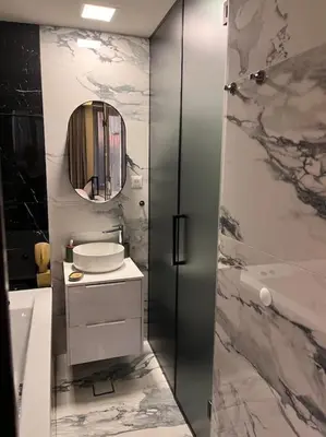 a bathroom with a sink and a shower with a mirror at Pleasure Apartment - Belgrade Waterfront in Sajmište