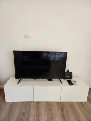 a flat screen tv sitting on a white entertainment center at Modern Cozy Suite - Vracar in Vračar (historical)