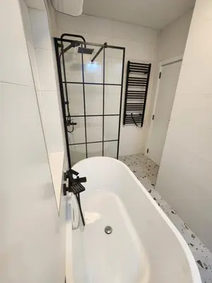 a white bath tub in a bathroom with a window at Modern Cozy Suite - Vracar in Vračar (historical)