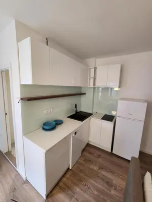 a kitchen with white cabinets and a blue bowl on a counter at Modern Cozy Suite - Vracar in Vračar (historical)