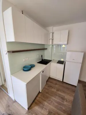 a kitchen with white cabinets and a white refrigerator at Modern Cozy Suite - Vracar in Vračar (historical)