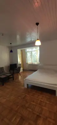 a large room with a large bed and a couch at Olimp Zvezdara in Mirijevo