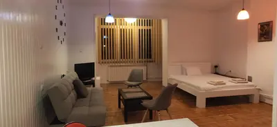 a living room with a bed and a couch at Olimp Zvezdara in Mirijevo