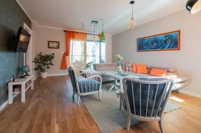 a living room with a table and a couch at Apartment Nar in Karaburma