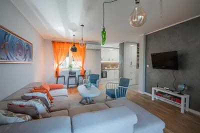 a living room with a couch and a table at Apartment Nar in Karaburma
