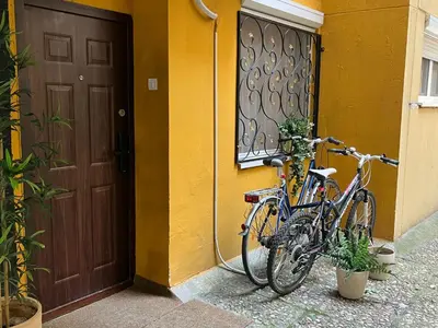 two bikes parked next to a building with a door at Piano Luxe Apartment with Sauna in Novi Beograd