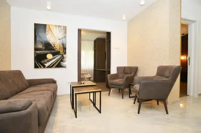 a living room with a couch and chairs and a table at Piano Luxe Apartment with Sauna in Novi Beograd
