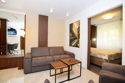 a living room with a couch and a bed at Piano Luxe Apartment with Sauna in Novi Beograd