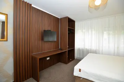 a bedroom with a bed and a tv on a wall at Piano Luxe Apartment with Sauna in Novi Beograd