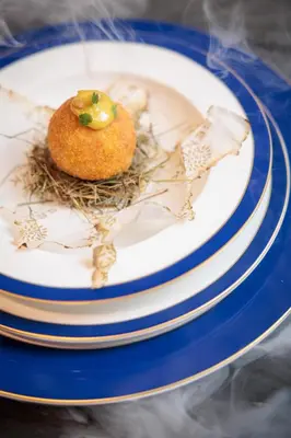 a plate with a piece of food on it at Radisson Collection Hotel, Old Mill Belgrade in Belgrade