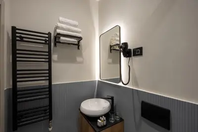 a bathroom with a sink and a mirror at Hop Inn Rooms & Suites in Belgrade
