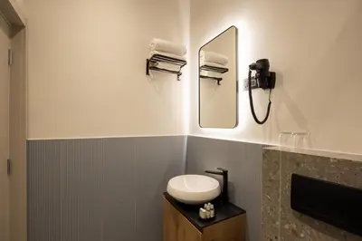 a bathroom with a sink and a mirror at Hop Inn Rooms & Suites in Belgrade