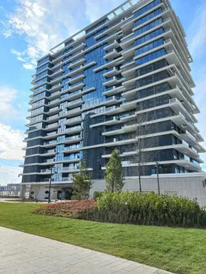 a large apartment building with a park in front of it at BW Royal Dream in Belgrade
