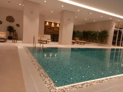 a swimming pool in the middle of a building at BW Royal Dream in Belgrade