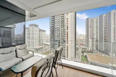 a living room with a couch and a large window at BW Royal Dream in Belgrade