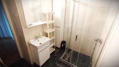 a bathroom with a white sink and a shower at ParkWest Arena Belgrade Lux Apartment in Belgrade