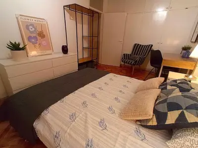 a bedroom with a bed and a desk and a chair at ParkWest Arena Belgrade Lux Apartment in Belgrade