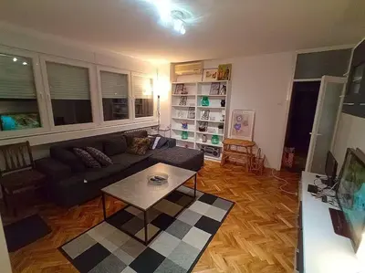 a living room with a couch and a table at ParkWest Arena Belgrade Lux Apartment in Belgrade